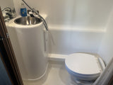 RV rental compact wet bath: all-in-one sink, toilet, and shower solution for travel efficiency.