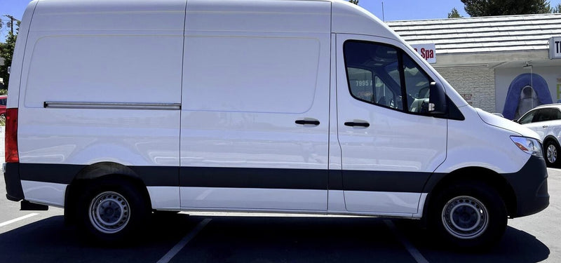 A clean white cargo van, often chosen for RV rental conversions, parked on asphalt. — photo 9