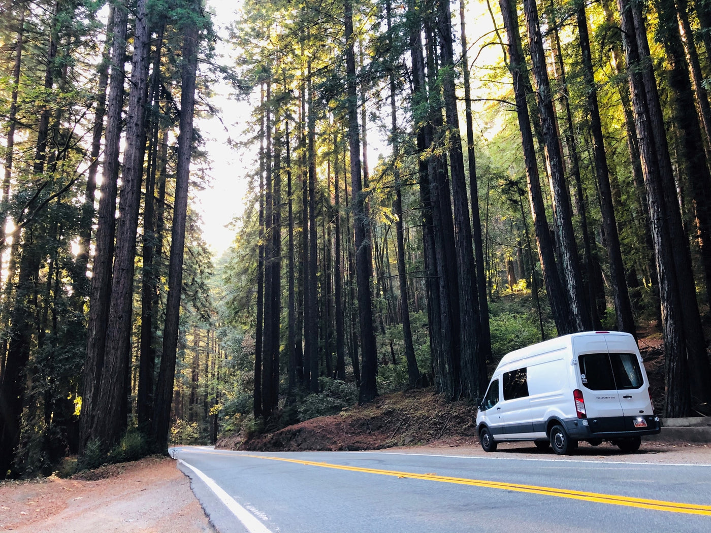  and built-in storage for comfy travels.|Desert adventure with an RV rental. A woman next to a white camper van on a sunny road — photo 11
