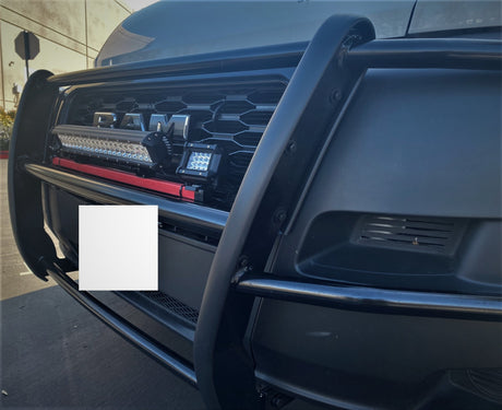 Close-up of a black RAM truck's grille, brush guard, and powerful LED lights. Perfect for heavy-duty RV rental towing.