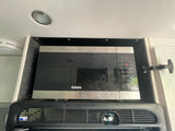 This rv rental features a built-in Galanz air fry microwave above a Norcold refrigerator.