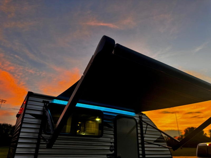  grill & truck.|RV rental adventure setup! Travel trailer & truck on grass with awning & mat under a vibrant sunset sky — photo 4