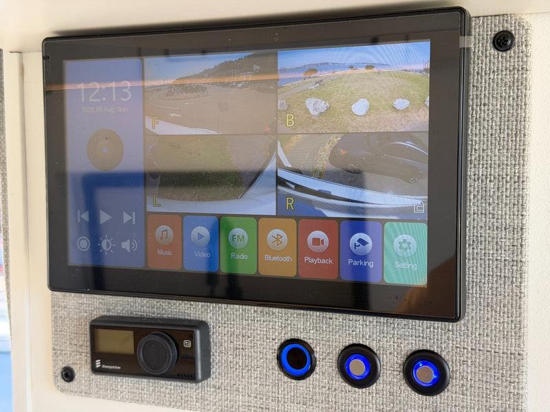  offering a scenic view of a sunny waterfront with distant boats and land.|RV rental dining space with plates & forks offering panoramic views of the Seattle skyline and water.|RV rental kitchen setup: a Ninja air fryer — photo 20