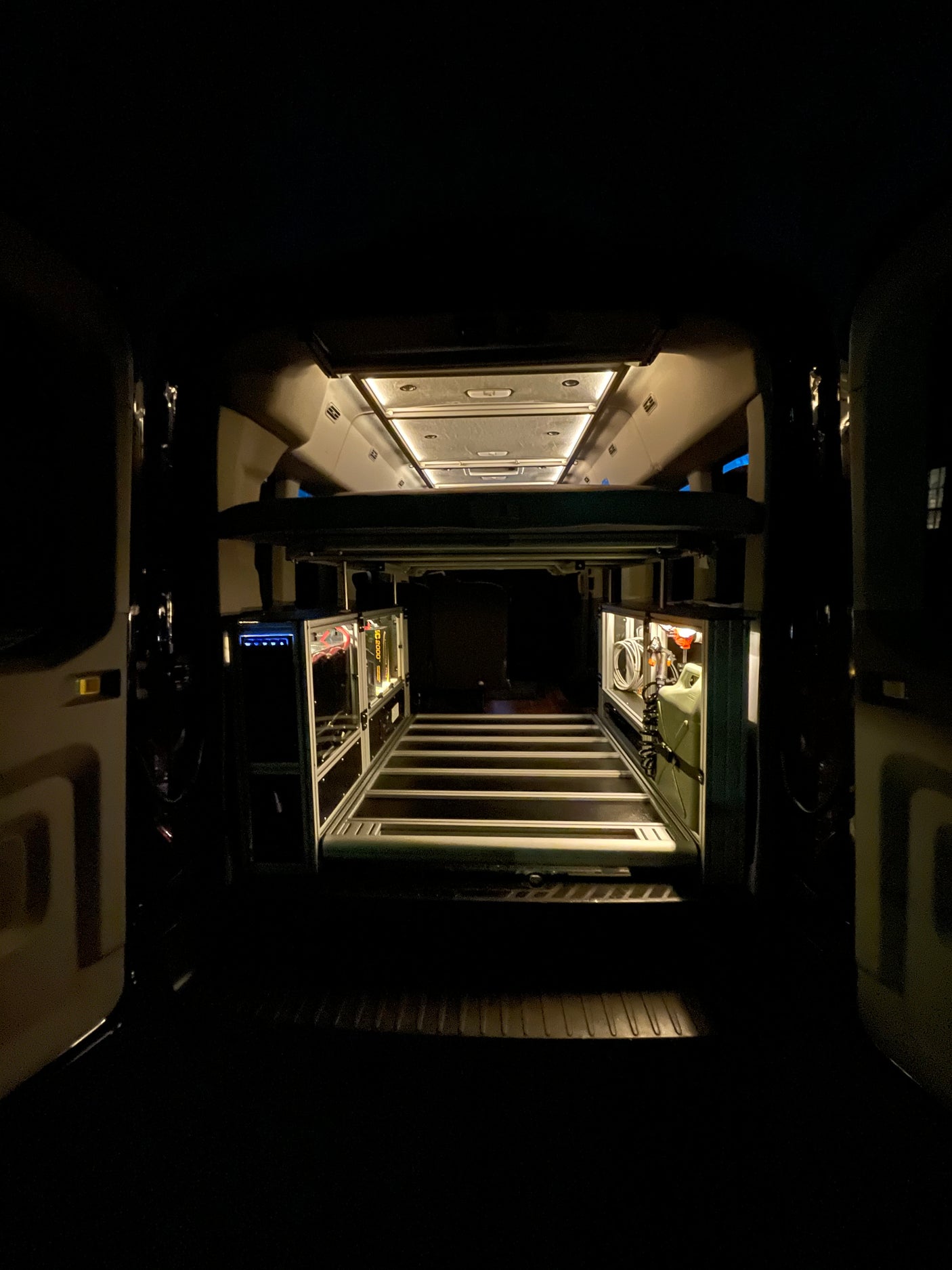 Get a clear view of this rv rental's clever interior design, showcasing smart storage, overhead lighting, and a raised bed.