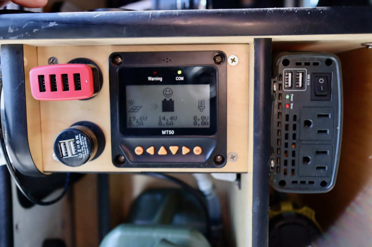 RV rental's power setup: solar charge controller (MT50), USB charging hub, and AC inverter for versatile mobile power.