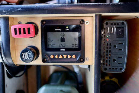 RV rental's power setup: solar charge controller (MT50), USB charging hub, and AC inverter for versatile mobile power.