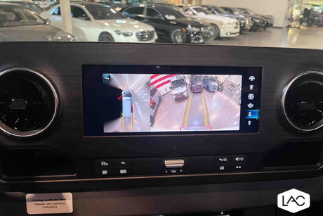 Inside an RV rental, the dashboard screen displays a 360-degree camera view for easy maneuvering in the lot.