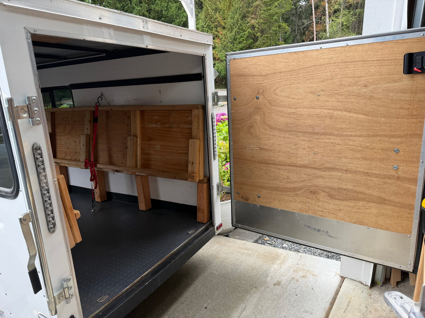  parked on concrete with a roof rack.|This white enclosed utility trailer — photo 10