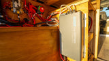 An RV rental's power system: Renogy 3000W inverter, fuse panel, and battery switch, neatly wired for off-grid living.
