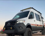 Explore in this rugged custom RV rental. White Sprinter van, off-road ready with lights & ladder for your adventure.