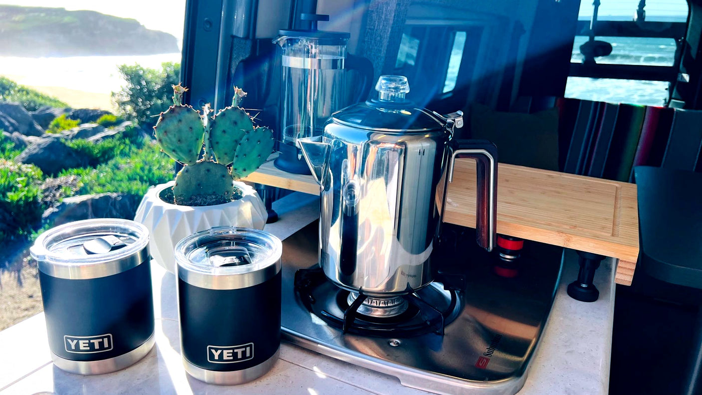 RV rental life: Beach views, coffee percolating on the stove, and a French press ready. Yeti mugs await!