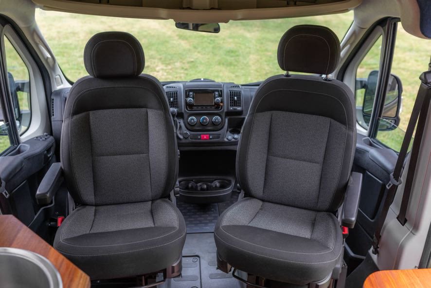 RV rental interior: Comfortable, swiveling driver and passenger seats with a clear view of the dashboard in the cabin. — photo 7