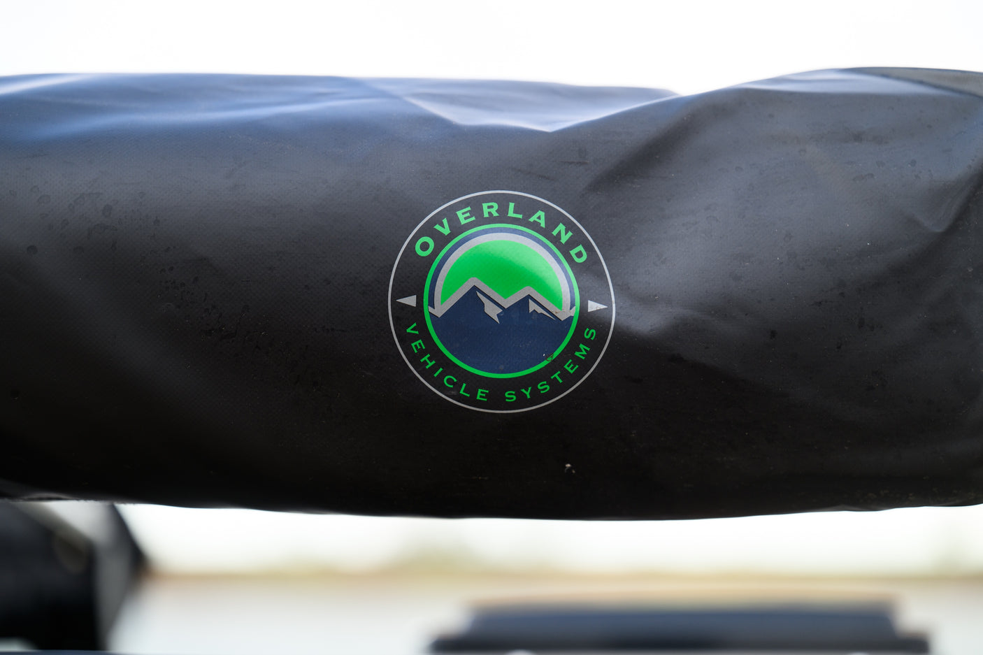 Black Overland Vehicle Systems awning cover, perfect for your next rv rental adventure, featuring the brand's mountain logo.