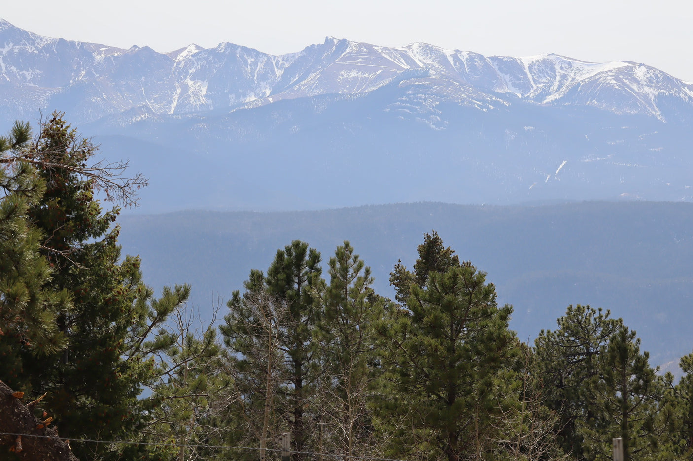 RV rental adventure: Snow-capped mountains rise above lush pine forests, offering a breathtaking scenic getaway.