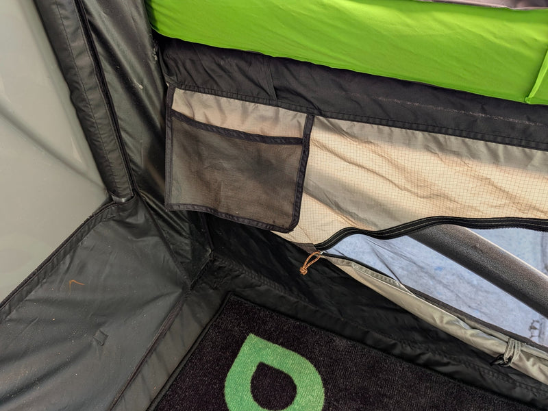  showcasing the sleeping area and cozy setup. Ideal for your next RV rental adventure.|Green SylvanSport camper's gray storage — photo 20