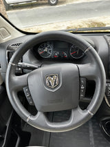 Inside an rv rental: Ram steering wheel with controls & dashboard gauges visible for the driver.