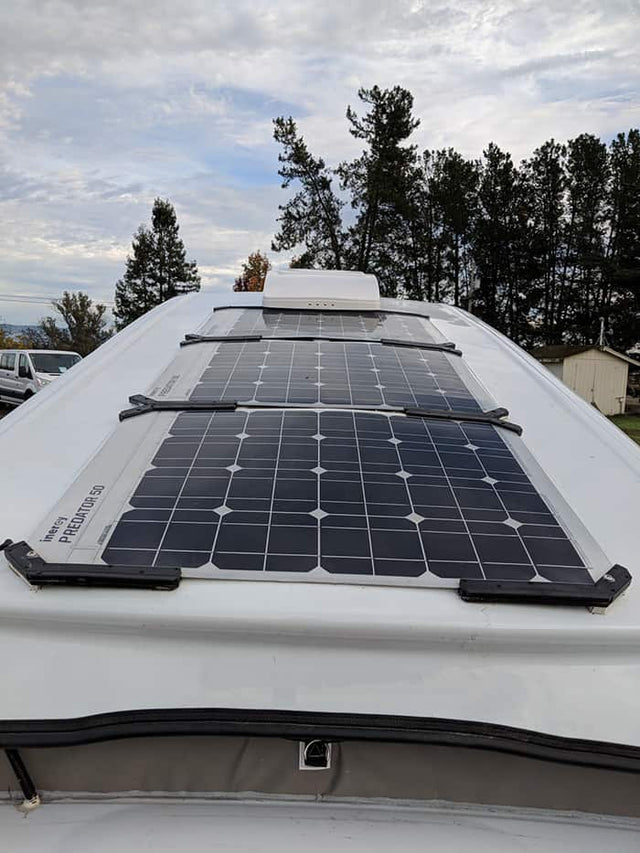  parked on asphalt.|RV rental roof with multiple Inergy Predator 50 flexible solar panels