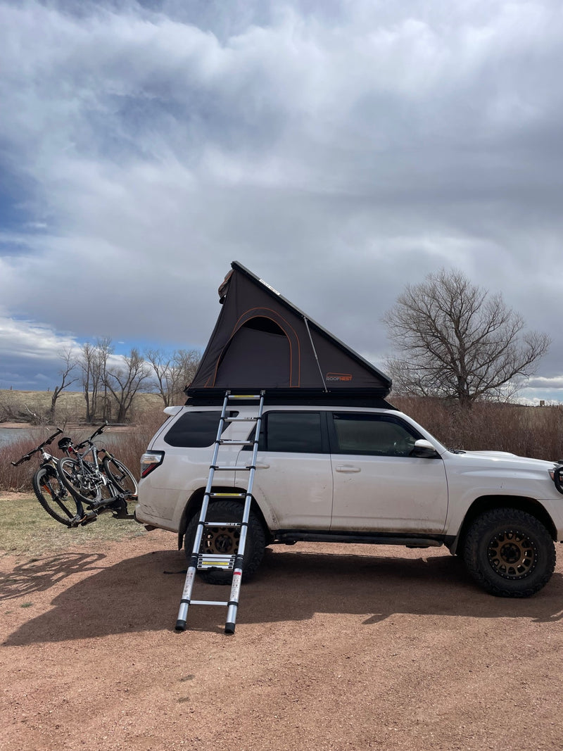 Adventure-ready SUV with a Roofnest rooftop tent, ladder, and bike rack is ideal for your next RV rental road trip. — photo 15