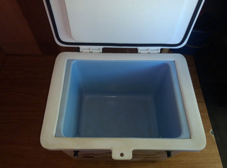 Inside an open, white cooler with a light blue interior, ready for your RV rental adventure. Great for travel storage!