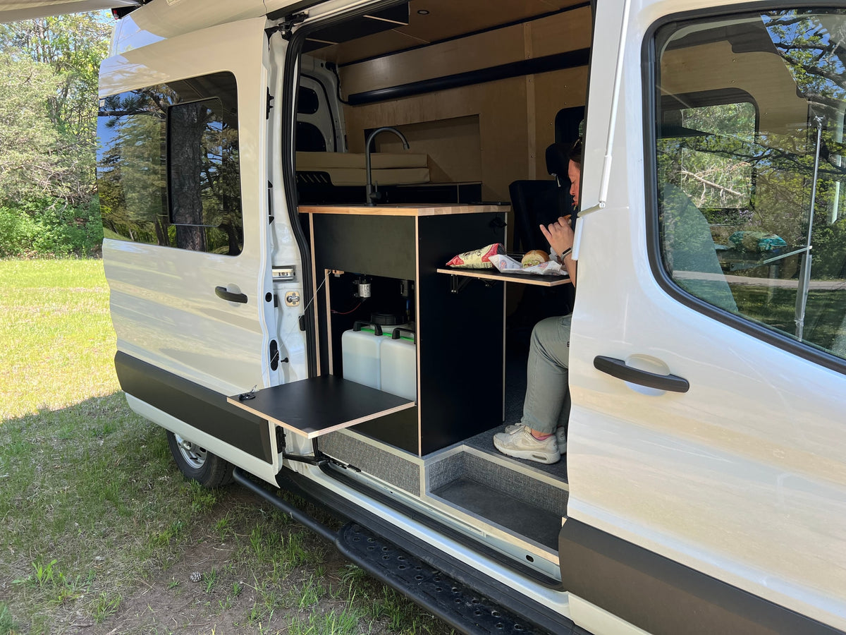  featuring a modern kitchen and wood paneling.|Inside an RV rental — photo 6