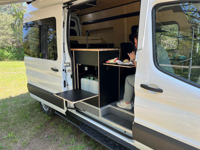  featuring a modern kitchen and wood paneling.|Inside an RV rental — photo 6