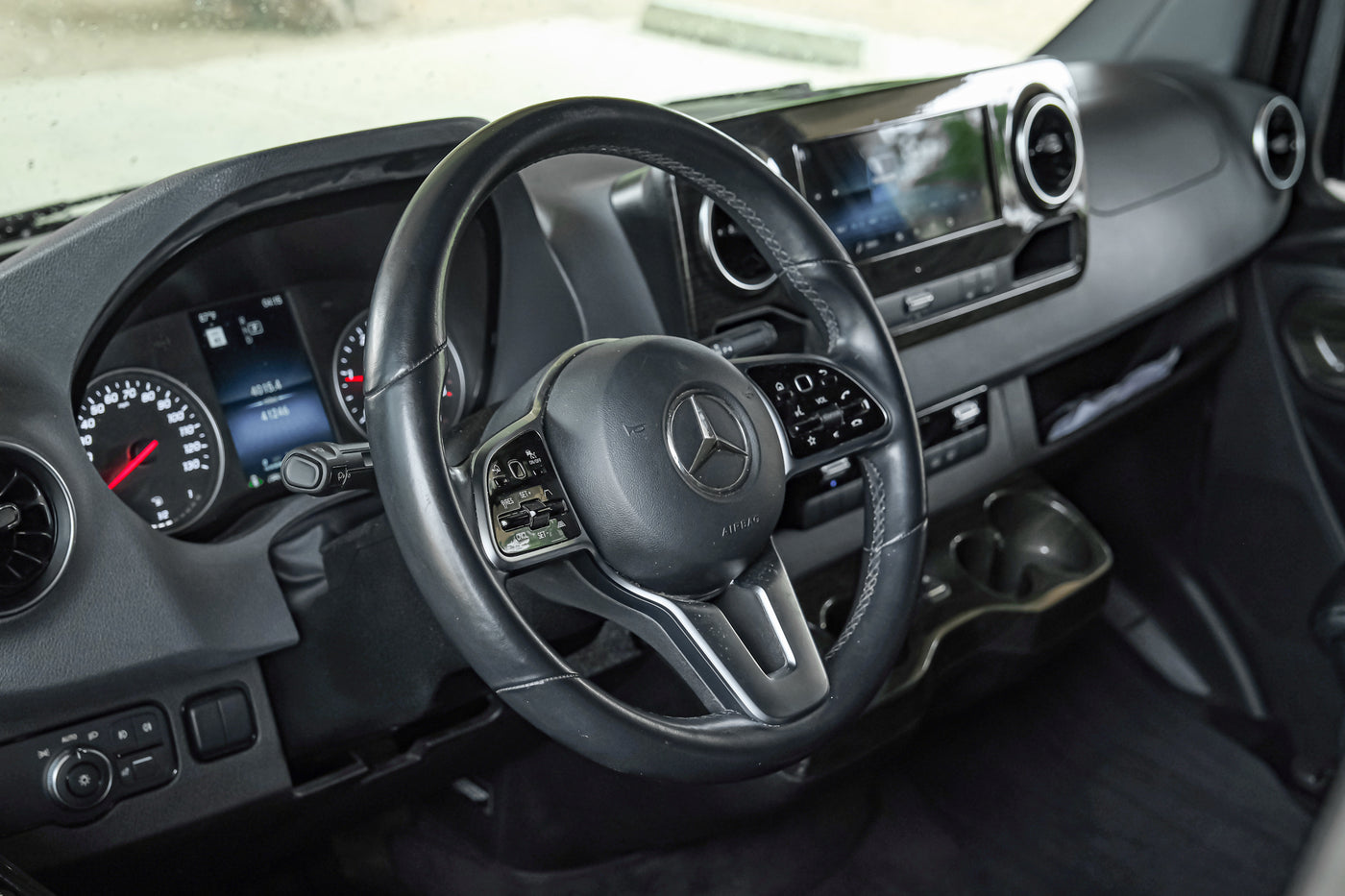Driver's perspective inside a modern RV rental, showing the Mercedes-Benz dashboard, steering wheel, and instrument cluster. — photo 20