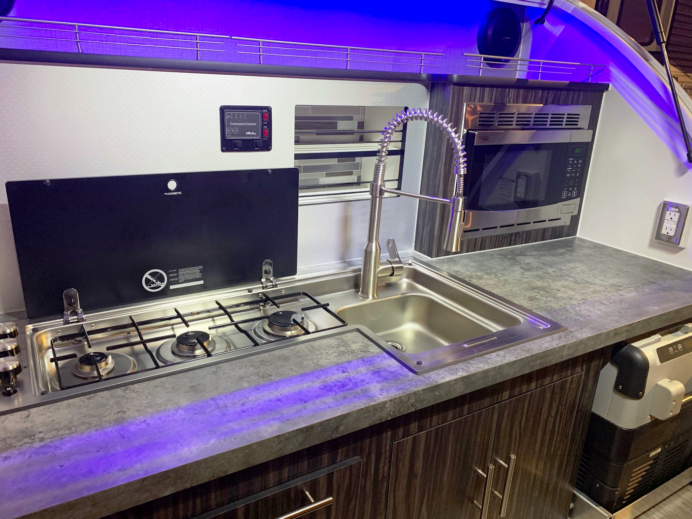 Explore in comfort! This rv rental galley features a stove, sink, microwave, & LED lighting.