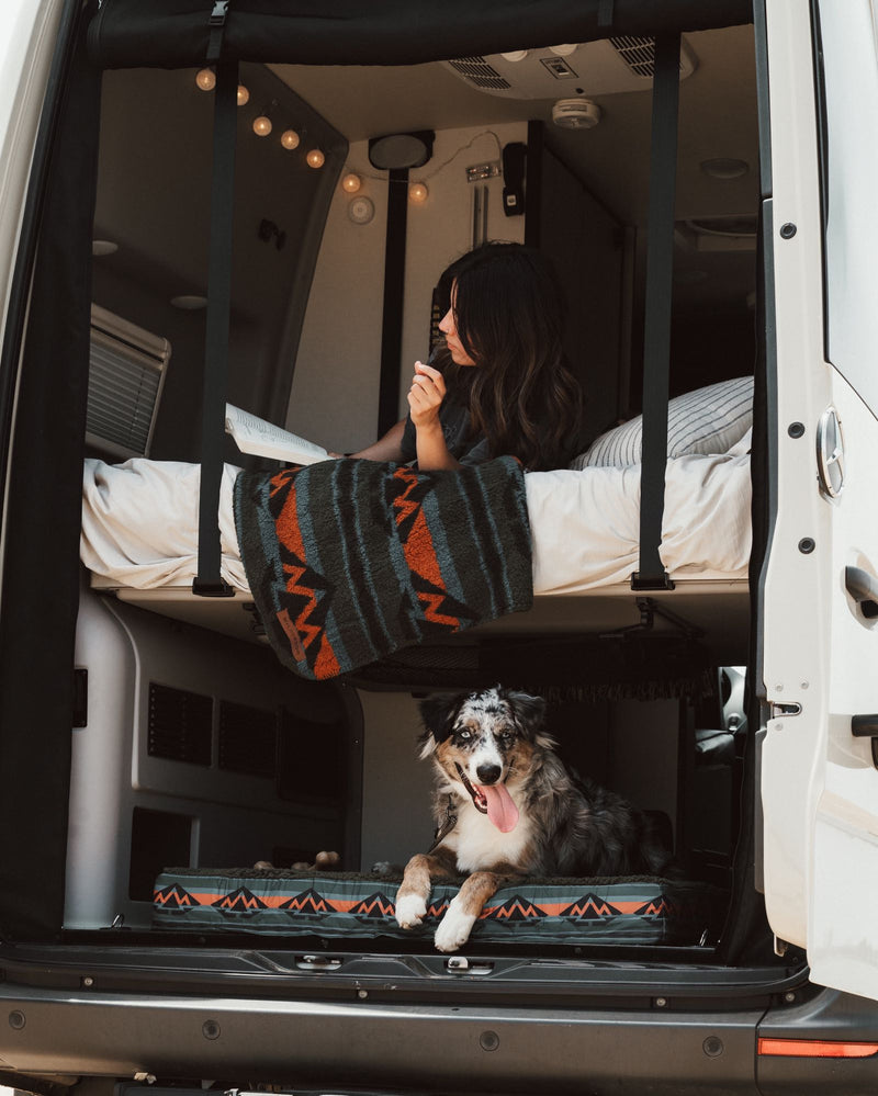  perfect for an off-grid nature adventure.|Cozy RV rental bedroom with an open book and stunning beach view — photo 2