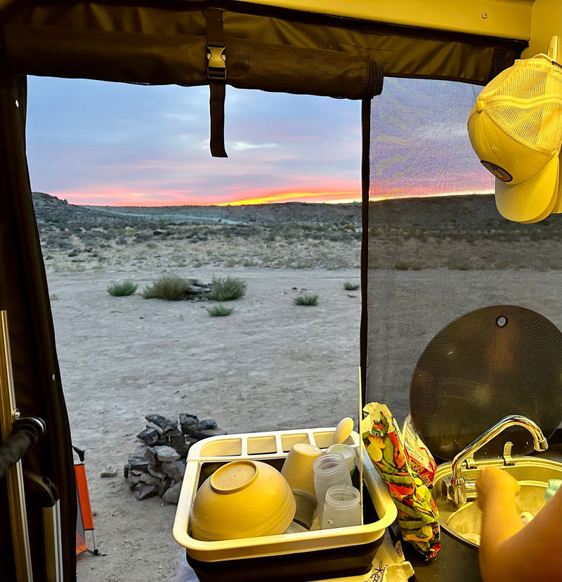  and bright lime green cabinets lead to the driver's area under warm lighting.|Stylish **rv rental** interior: kitchenette — photo 20