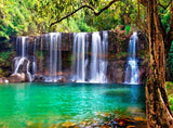Vibrant waterfall in lush forest with turquoise pool. An RV rental is perfect for this serene nature escape.