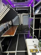 Spacious, modular Vandoit camper van interior, ideal for RV rental adventures, featuring a fold-down bed and storage.