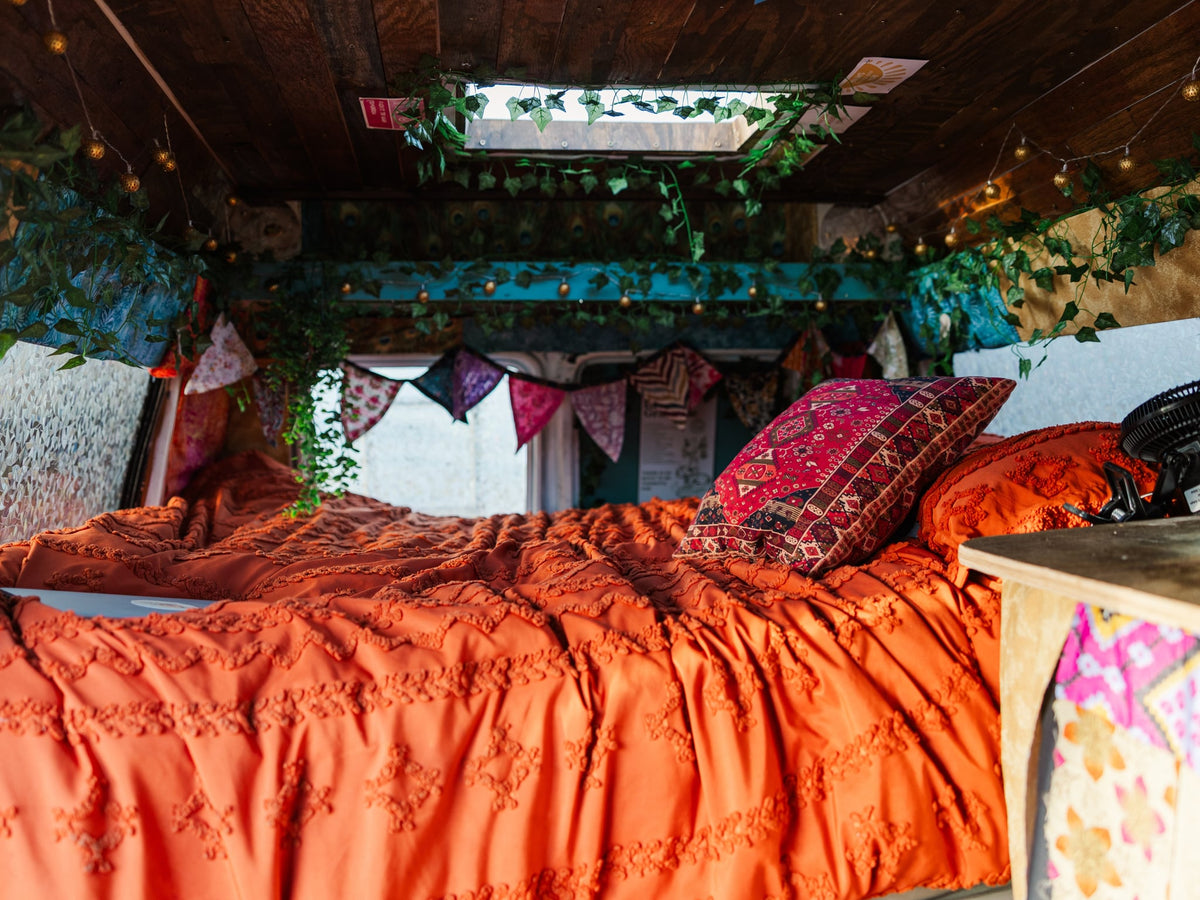  wavy paint design and high roof.|RV rental's cozy interior: 'Mindful Energy' sign — photo 12