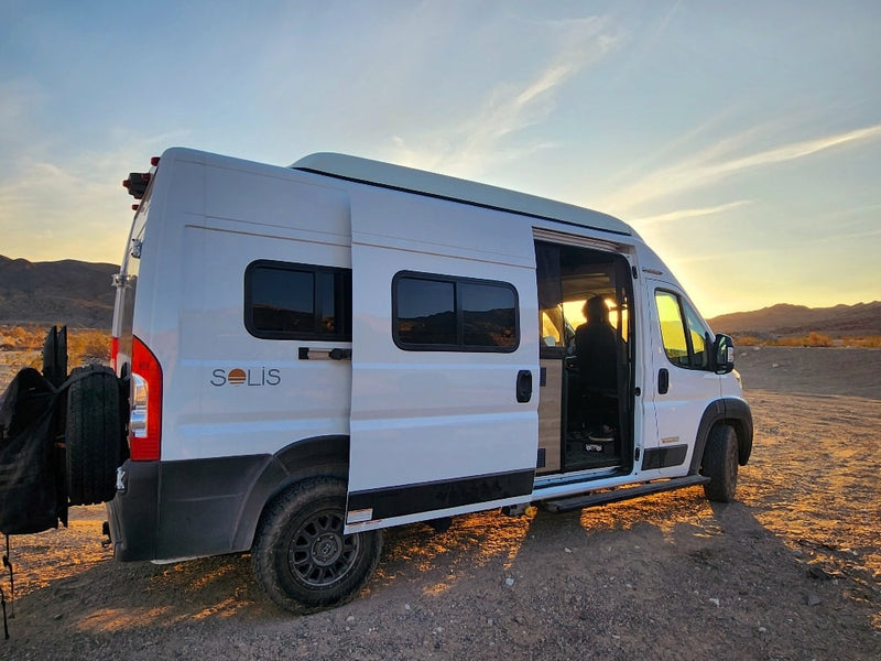  illuminated by a vibrant sunset.|White Solis camper van for RV rental — photo 2