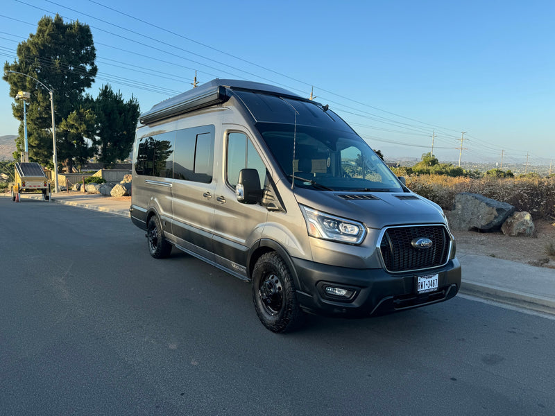  & photographer's reflection in the window.|A champagne-colored ModVans Ford Transit camper — photo 8