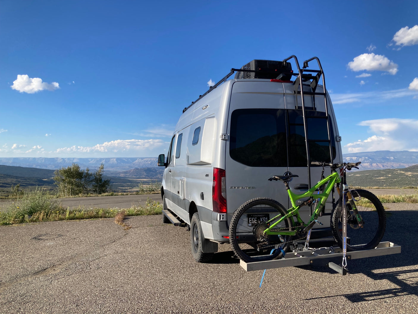 Explore Colorado's beauty with this RV rental. A Sprinter van and bike are ready for mountain adventures.