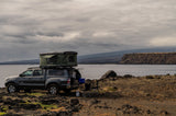 Coastal RV rental truck with rooftop tent and camp setup, perfect for overlanding.