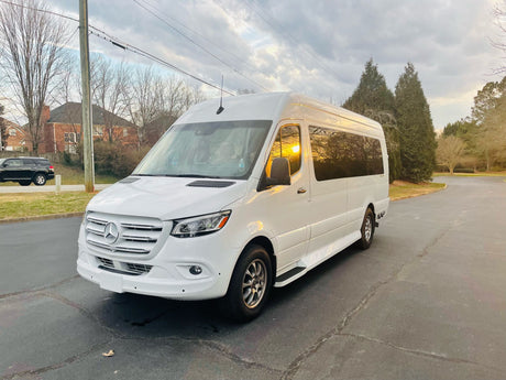 A white Mercedes-Benz Sprinter van, ideal for your next rv rental adventure, parked on asphalt.
