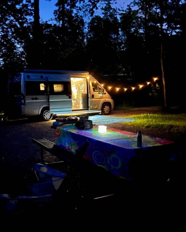  and sleek wood-grain floor. Outside is a garage.|Enjoying a refreshing Truly Hard Seltzer in a convenient cup holder inside an RV rental. Perfect for travel!|RV rental interior featuring privacy curtains