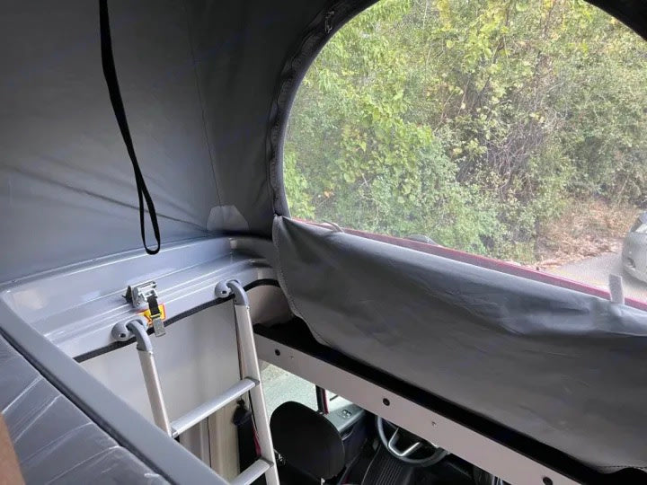  featuring a two-burner Suburban gas cooktop with a stainless steel surface and lighting instructions.|Enjoy serene desert views from a comfy RV rental bed — photo 15
