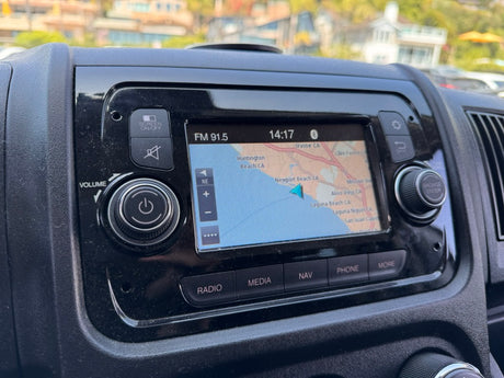 An RV rental's dashboard infotainment system displays navigation for Southern California, FM 91.5, and time, with radio/volume controls.