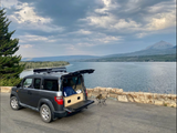 Car camping by the lake! This Honda Element, with its built-in platform, offers an RV rental alternative for scenic adventures.