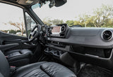 This rv rental van's interior showcases comfy black quilted seats, a modern Mercedes-Benz dashboard, and touchscreen for road trips.