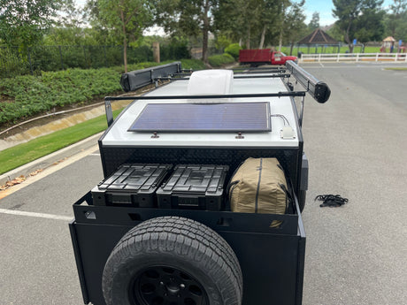 Compact adventure trailer, perfect for your next rv rental trip, equipped with solar power, awnings, and ample outdoor storage.