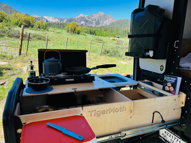 Scenic rv rental with a TigerMoth outdoor kitchen setup: Primus stove, sink, water, & a camping cookbook. — photo 9