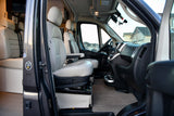 RV rental interior showcasing the driver's cabin with light seats, dashboard, and a glimpse into the comfortable living area.