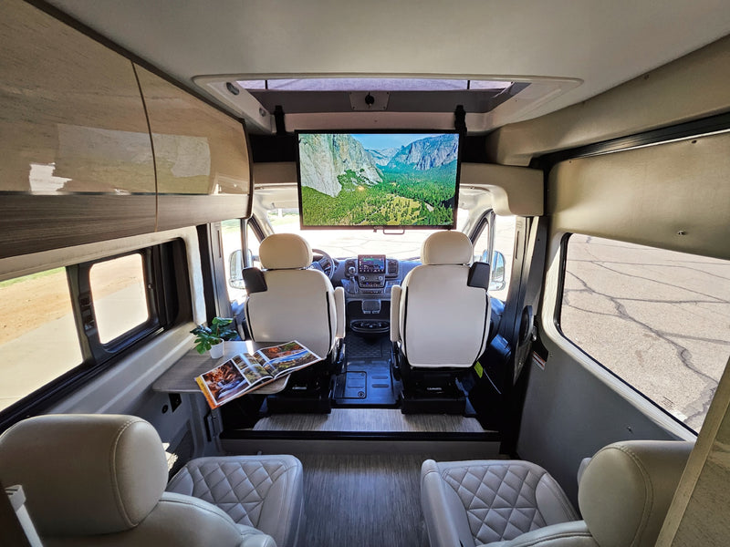  side door open. This modern camper van is ready for your next adventure!|Modern RV rental interior with swiveling front seats — photo 2