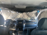 Cozy rv rental interior with quilted windshield covers for privacy and insulation. Overhead net storage and detailed dashboard visible.