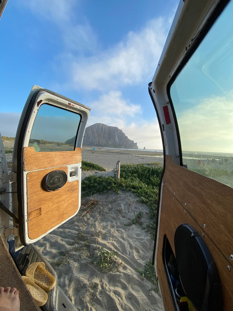 Open RV rental doors reveal a stunning beach scene with sand, ocean, and iconic Morro Rock in the distance. Perfect for scenic travels. — photo 15