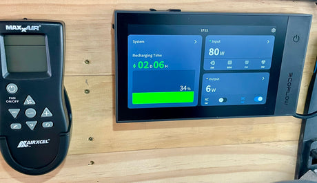 RV rental interior: MAXXAIR fan remote next to an ECOFLOW power station display showing 34% charge, 80W input, 6W output.