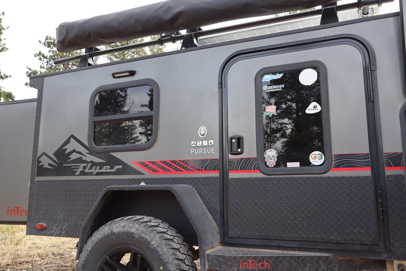 Adventure-ready inTech Flyer Pursue RV rental. This robust camper, with off-road tires, awning, and solar, is perfect for outdoor exploration.